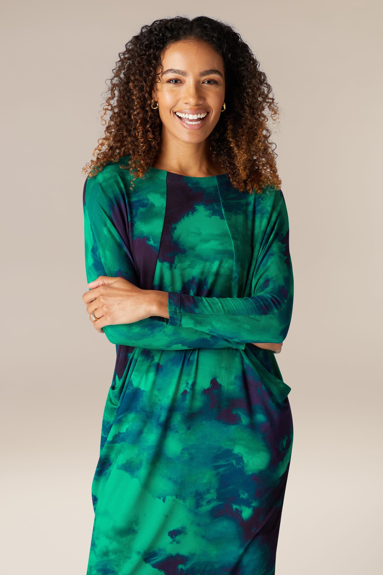 A woman wearing a green Jewelled Sky Jersey Dress.