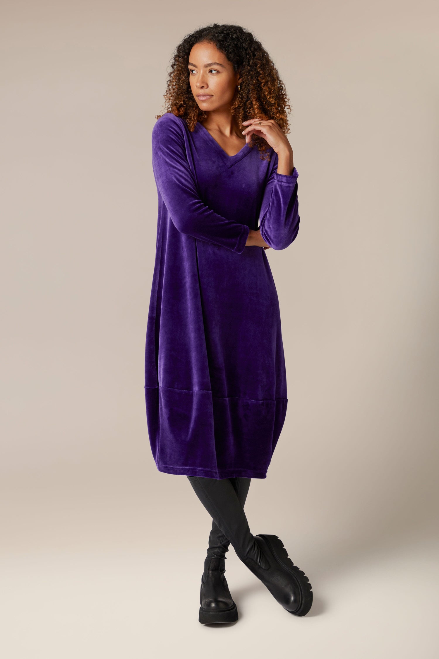 A woman donning a luxurious purple Velvet Jersey Bubble Hem Dress.