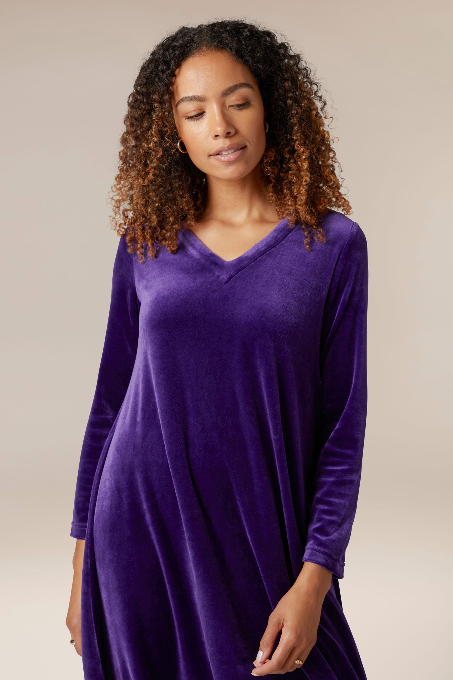 A woman wearing a luxury purple Velvet Jersey Bubble Hem Dress.