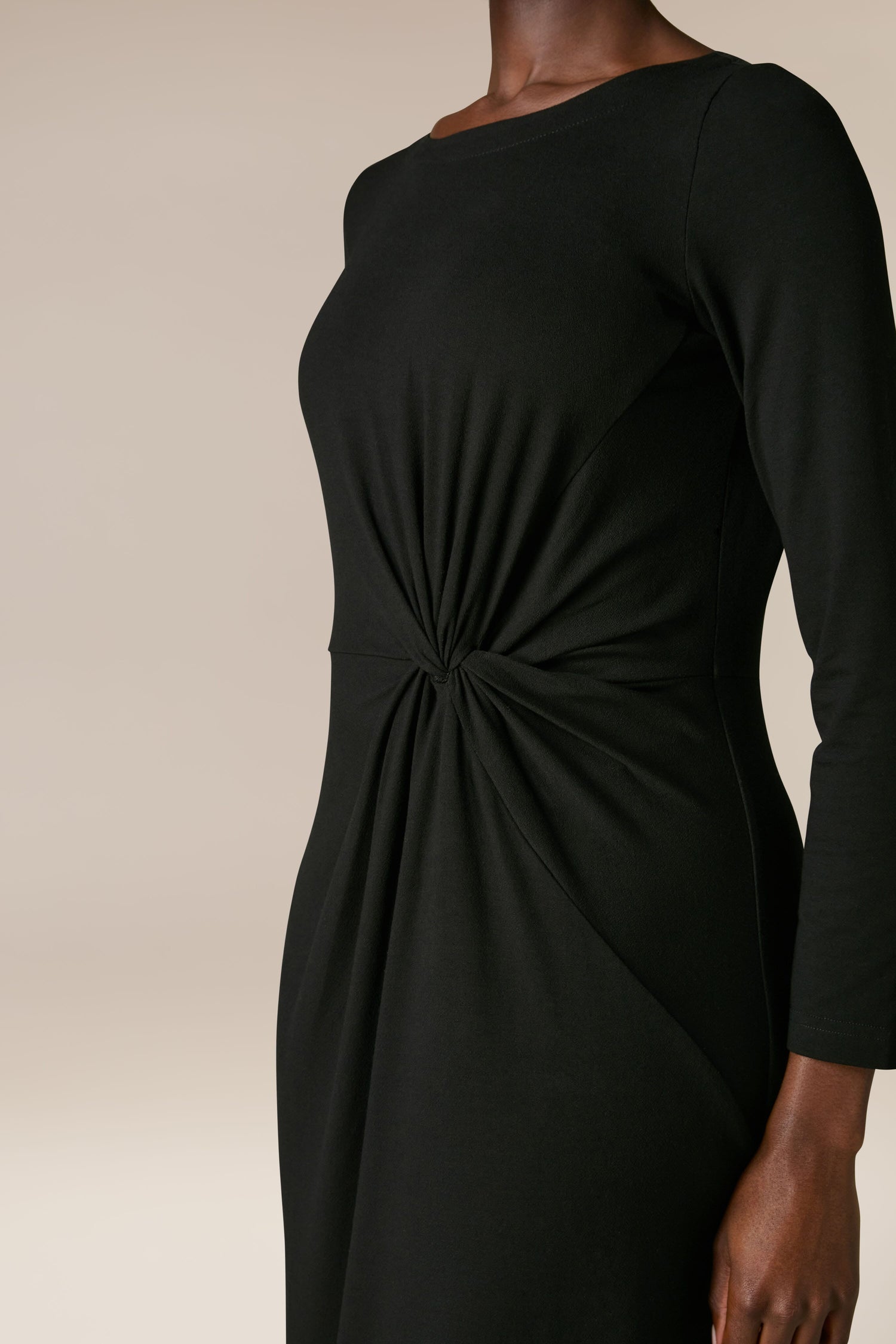 A person wearing the Fluid Crepe Knot Dress is shown from the neck to mid-thigh.