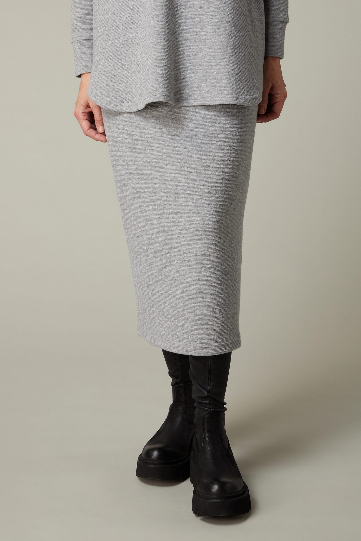 A woman wearing a Crinkle Jersey Tube Skirt.