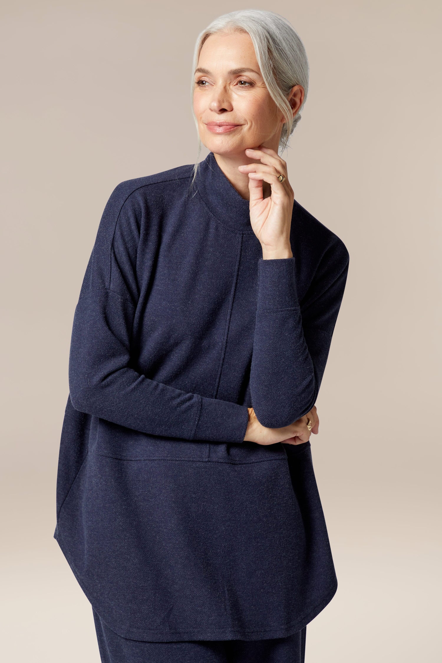 A woman wearing a Marl Jersey Sweatshirt, a wardrobe staple for any occasion.