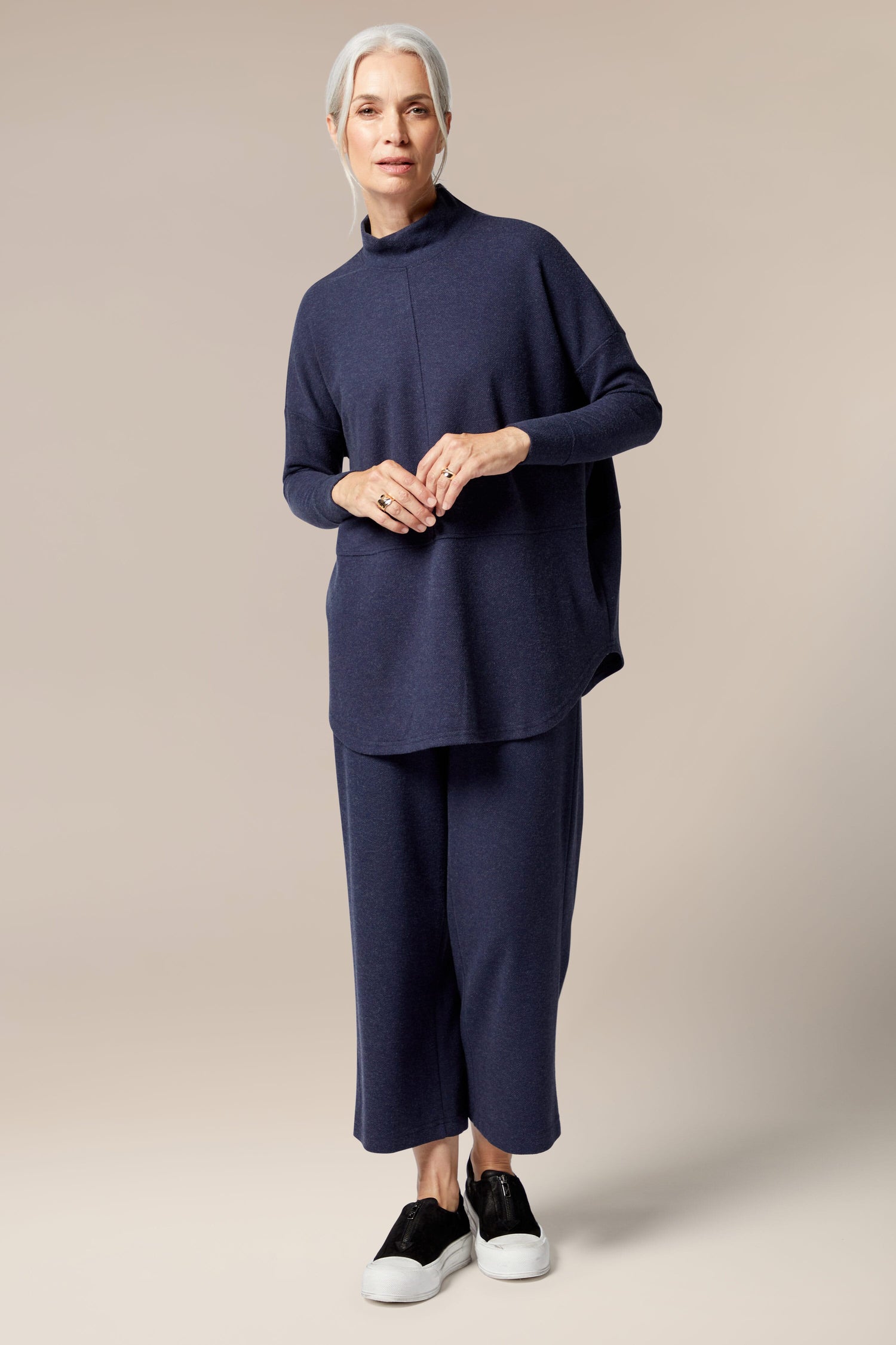 The model is wearing a Marl Jersey Sweatshirt and black pants.