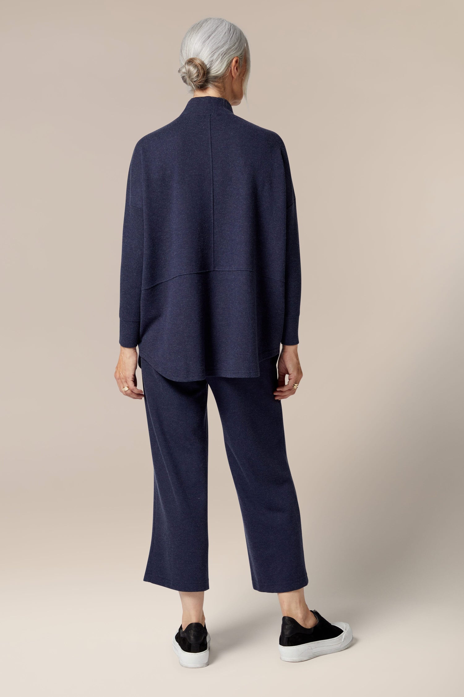 The back view of a woman wearing a Marl Jersey Sweatshirt, a wardrobe staple.