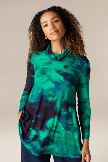 A woman wearing the Jewelled Sky Jersey Tunic made from Lenzing™ EcoVero™ Viscose, featuring a sky print.