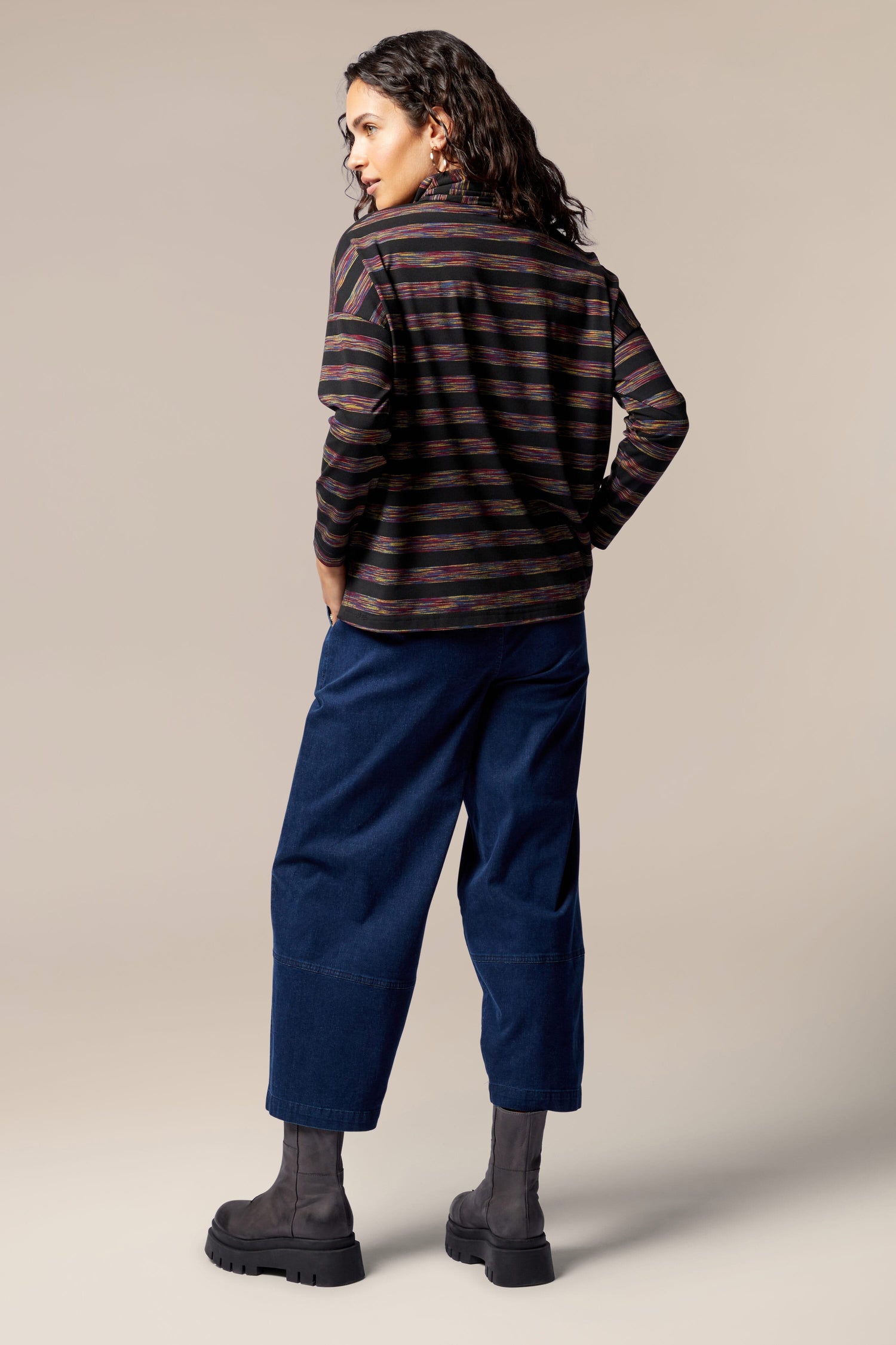 The back view of a woman wearing plush jersey striped pants and a Spacedye Stripe Cowl Neck Top.