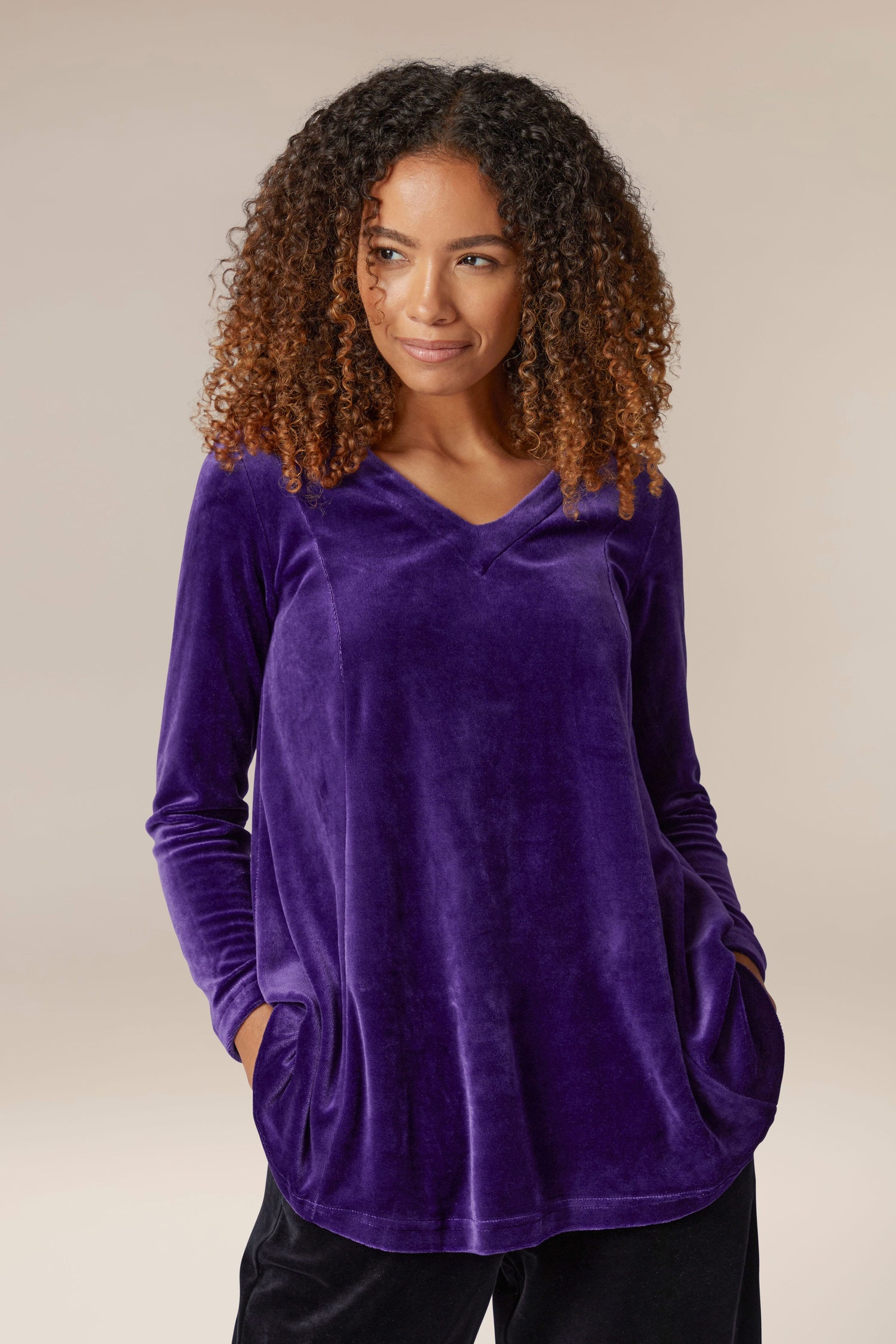 A woman wearing a luxury purple Velvet Jersey Swing Top.