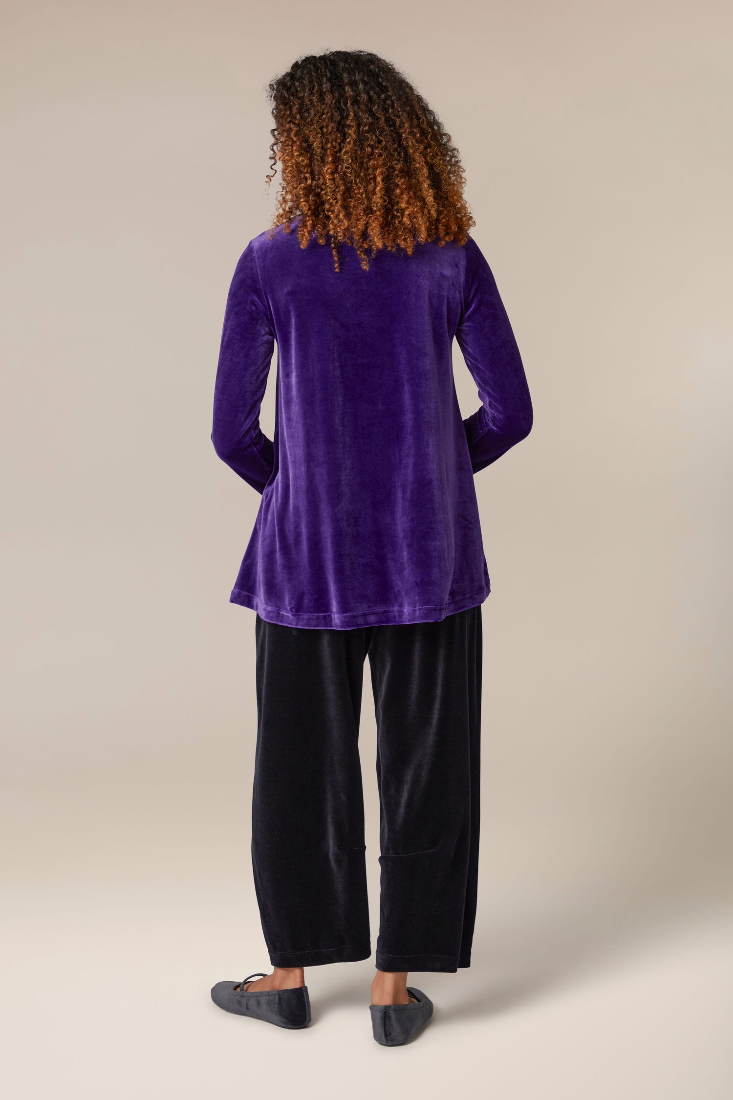 The luxurious back view of a woman wearing a Velvet Jersey Swing Top.
