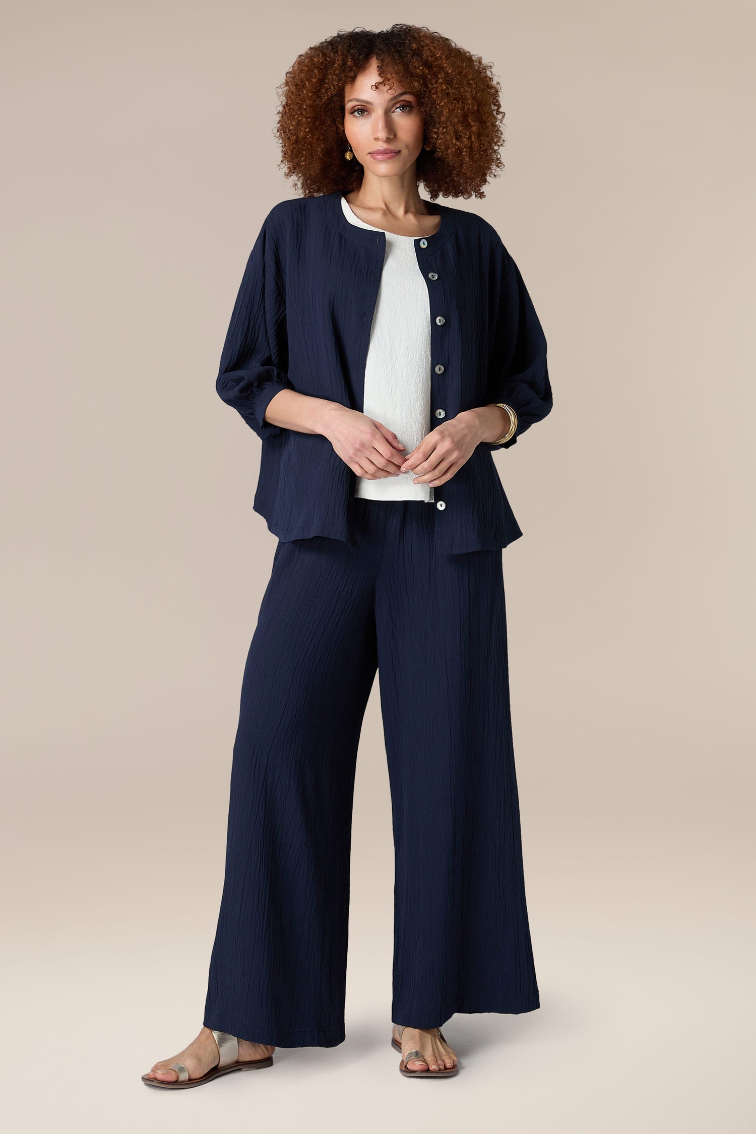A woman in a Crinkle Soft Viscose Shirt and wide leg pants is sporting a relaxed silhouette.