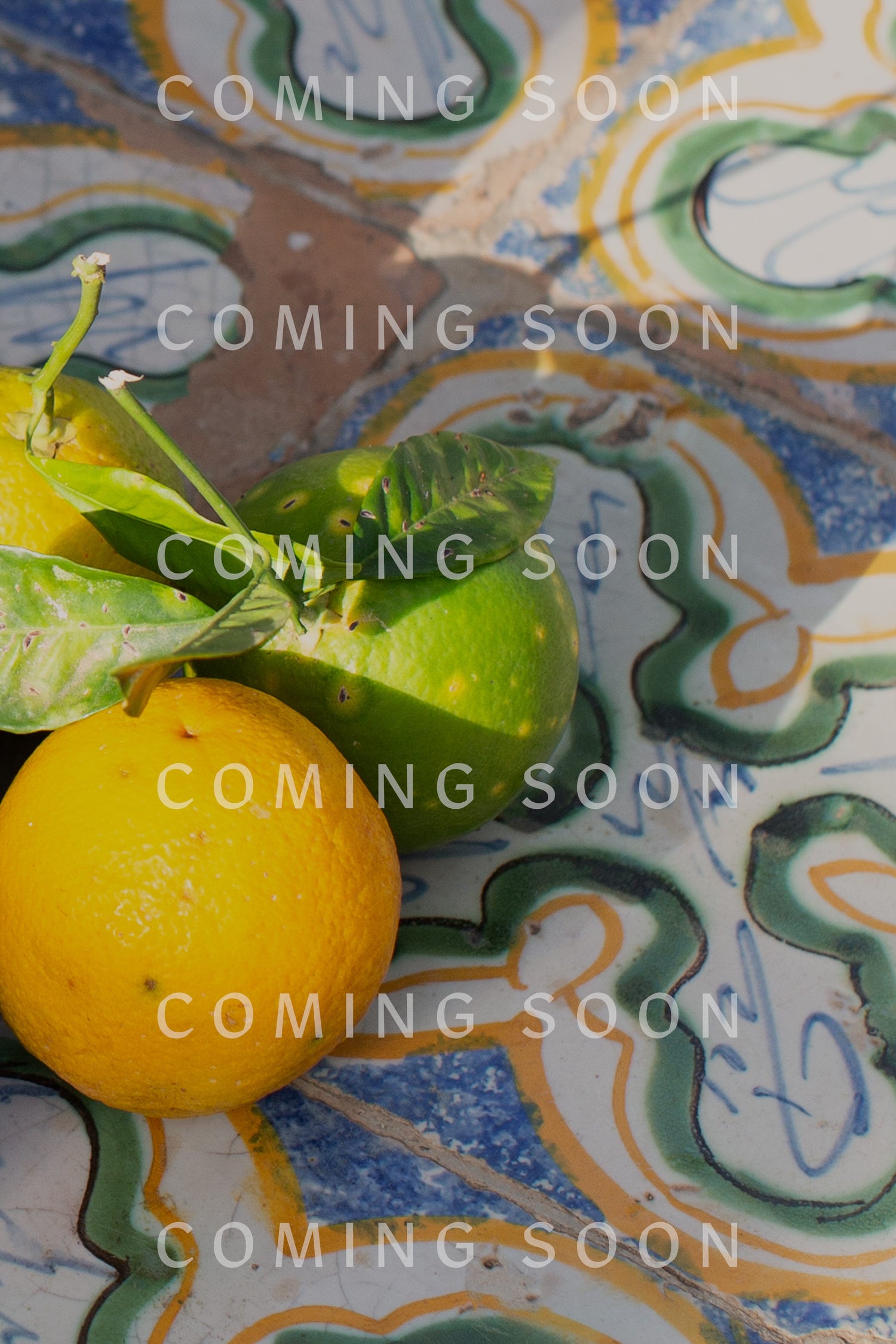 Oranges and lemons scattered on a tiled floor, alongside Twisted Linen Bubble Trousers with side pockets.