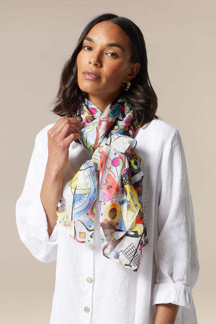 A woman wearing a Cubist Silk Scarf.