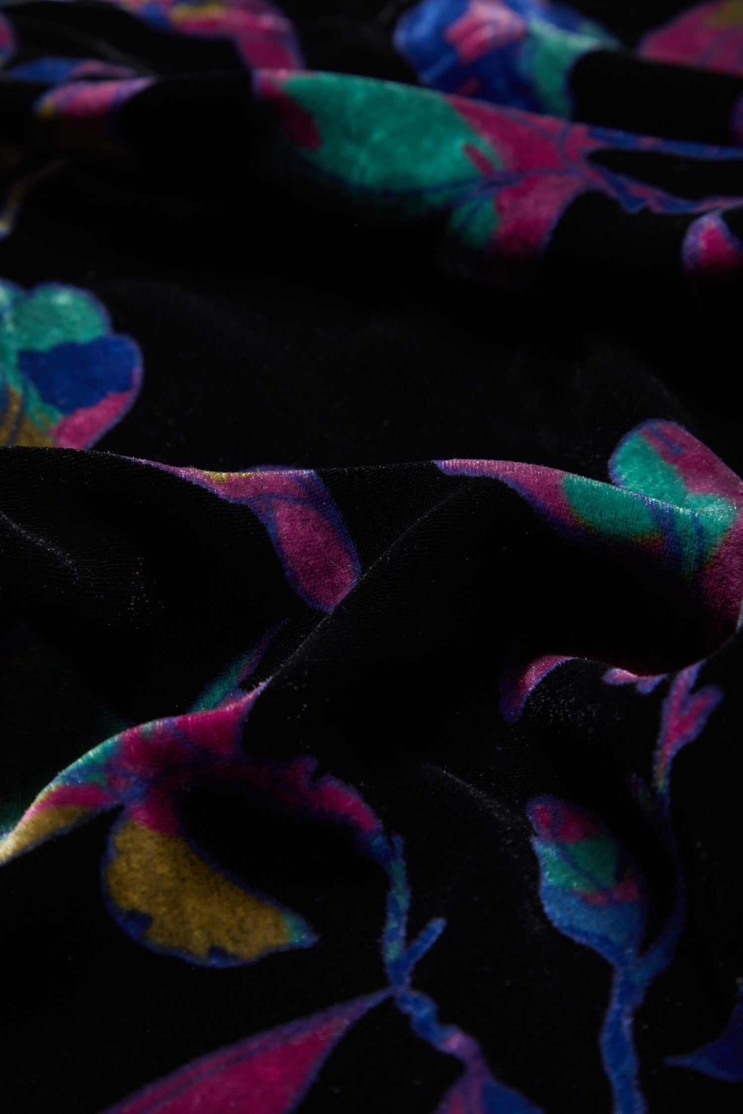A close up of a black velvet fabric with the Winter Magnolia Velvet Tunic.