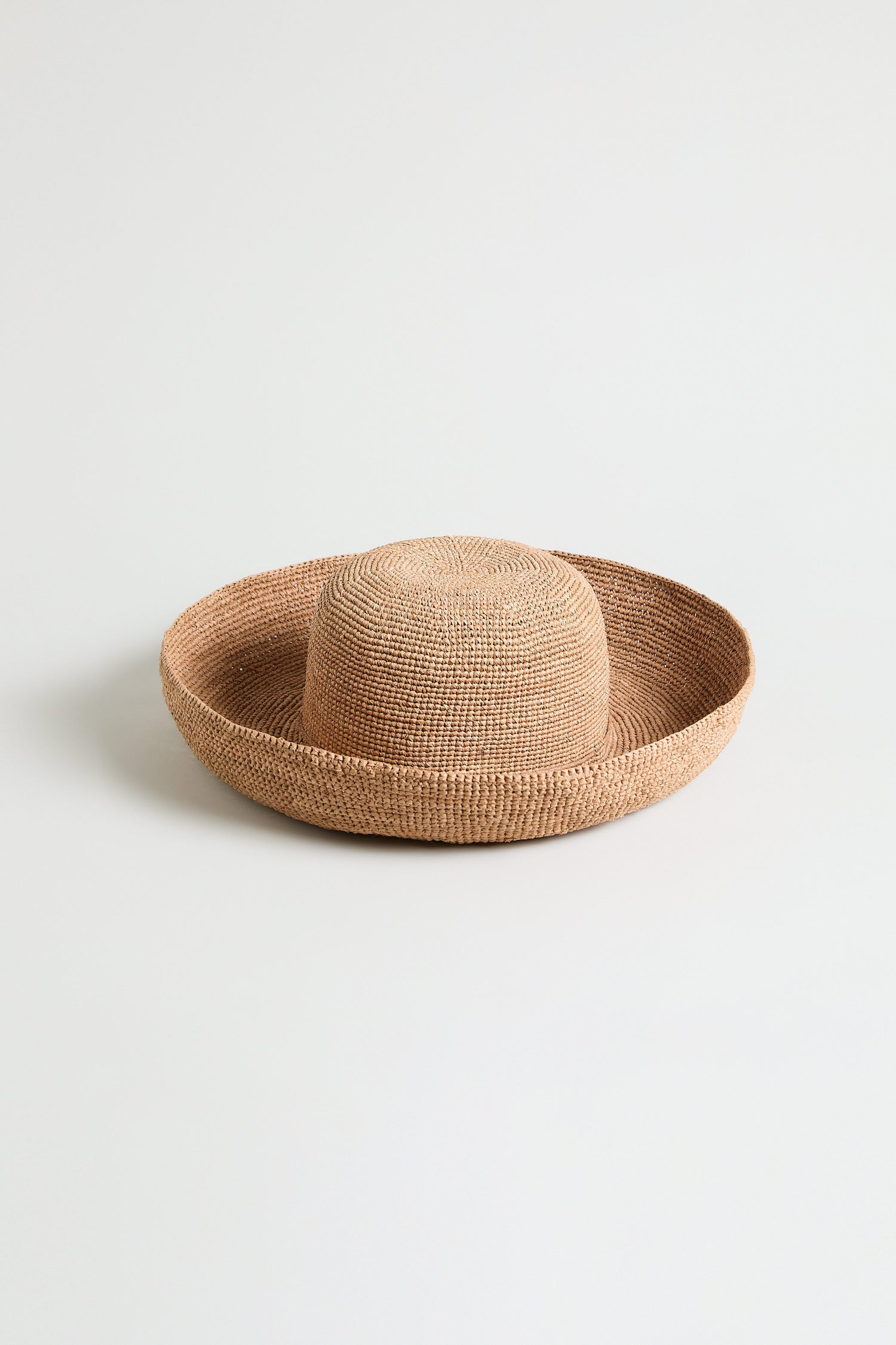 Handwoven Raffia Tie Hat with a rounded crown and wide, flat brim, displayed on a plain white background.
