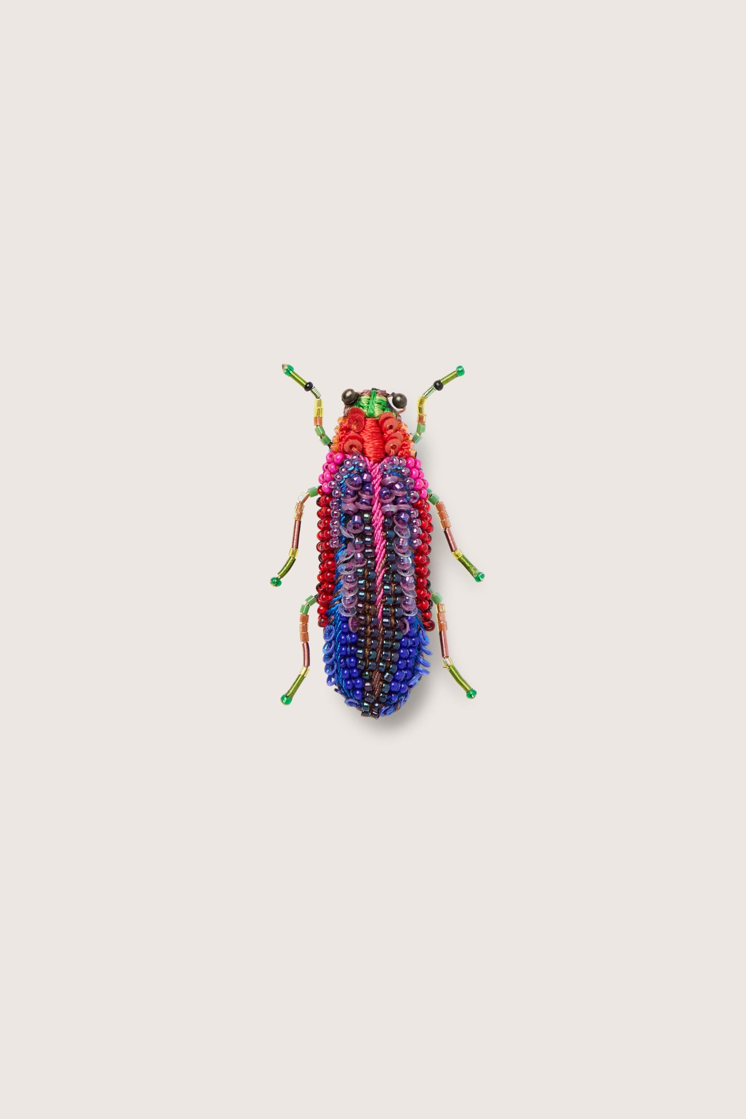 A sparkling Rainbow Leaf Beetle brooch featuring jewel tones on a white background.