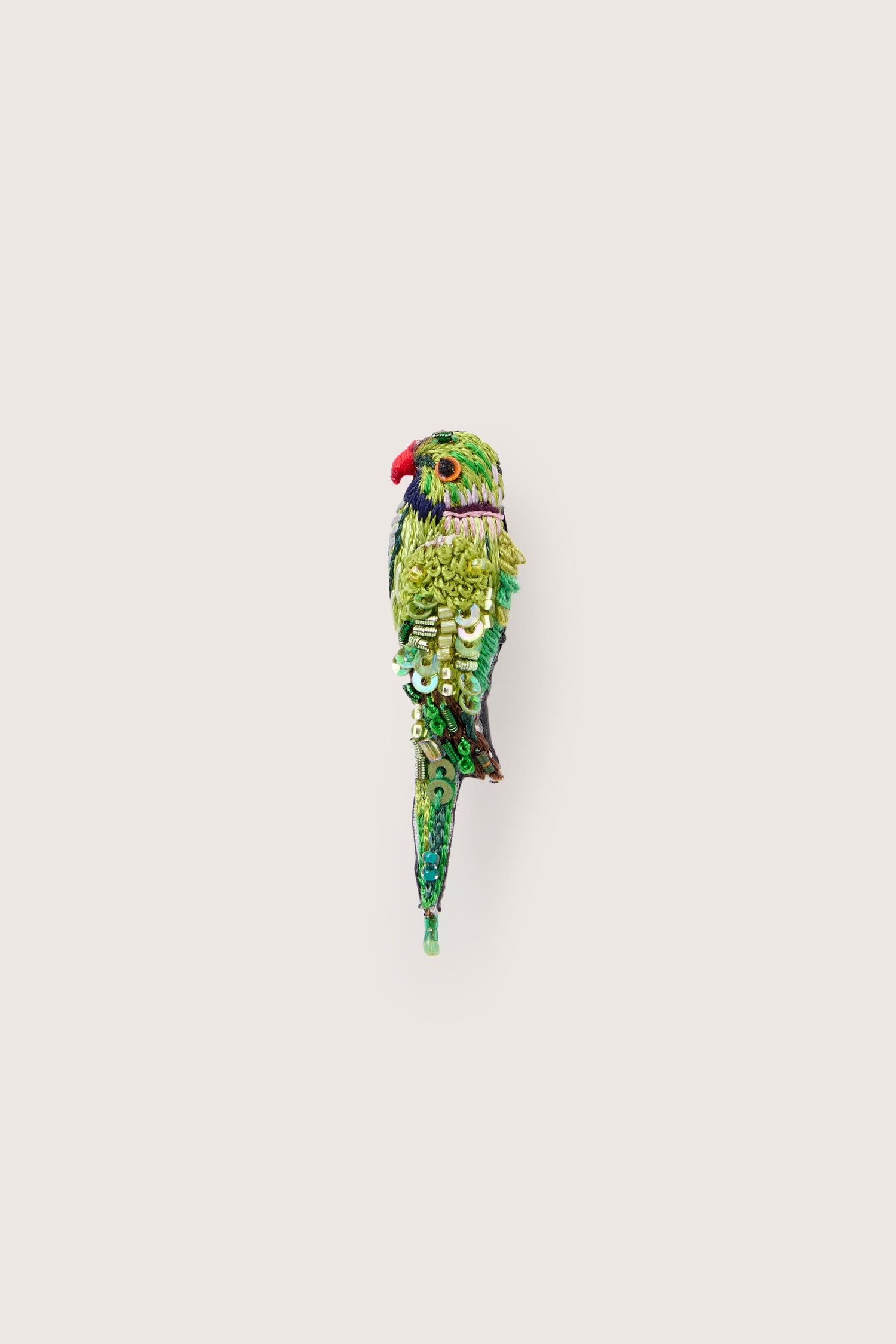 A Hand Embroidered Parrot Brooch sitting on top of a white background.