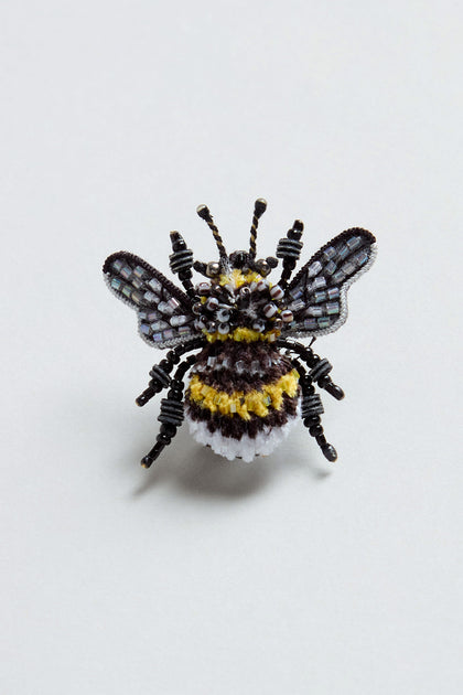 A Hand Beaded Yellow-Banded Bee Brooch, crafted from beads and fabric, is displayed on a plain light background.