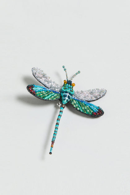 The Hand Embroidered Oriental Greenwing Dragonfly Brooch, featuring blue, green, and pink bead details, is displayed on a plain white background.