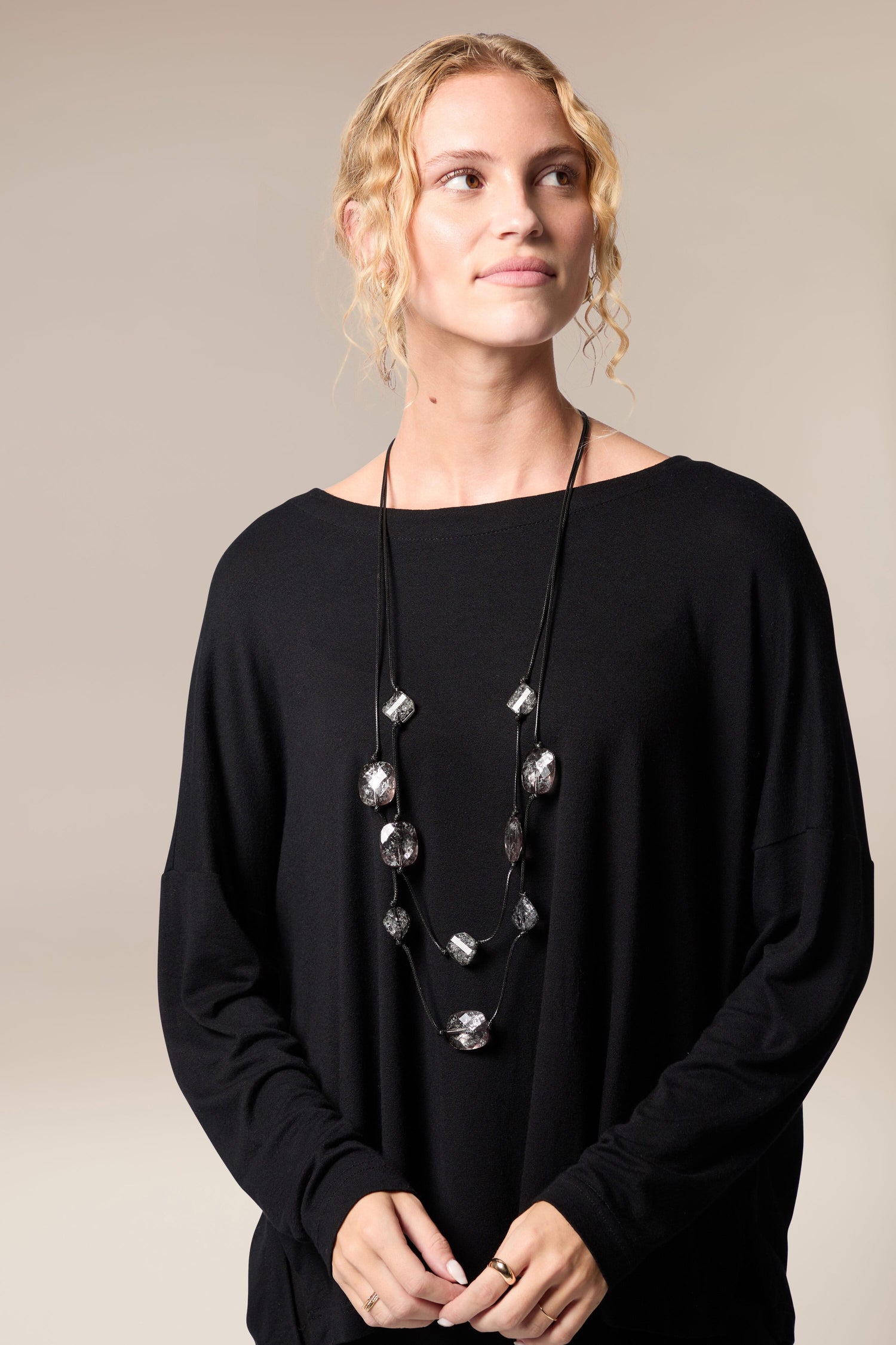 A woman wearing a black top and the Silver Leaf Pebble Necklace.