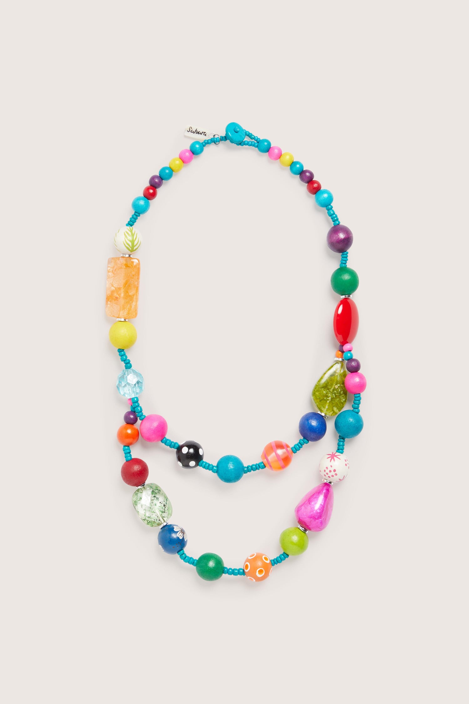 Colour Pop Rainbow Spheres Necklace with assorted sizes and shapes of whimsical beads, arranged in a loop on a white background.