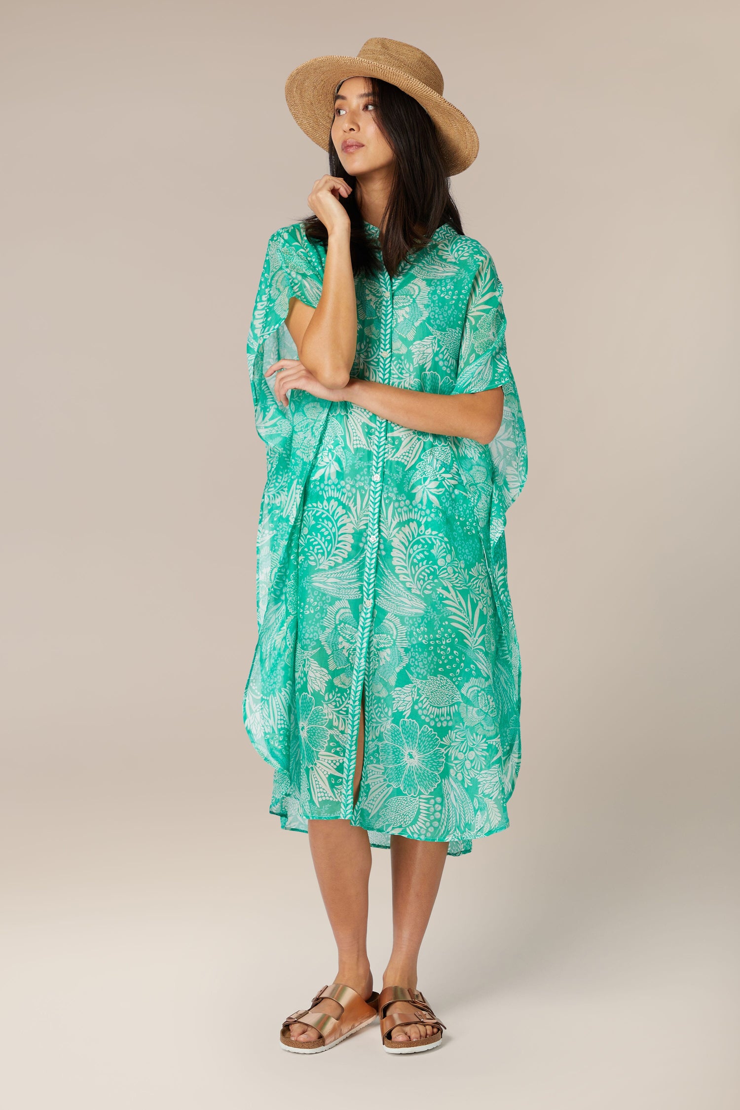 Woman in a Button Bouquet Shirt Dress with a hat posing against a neutral background.