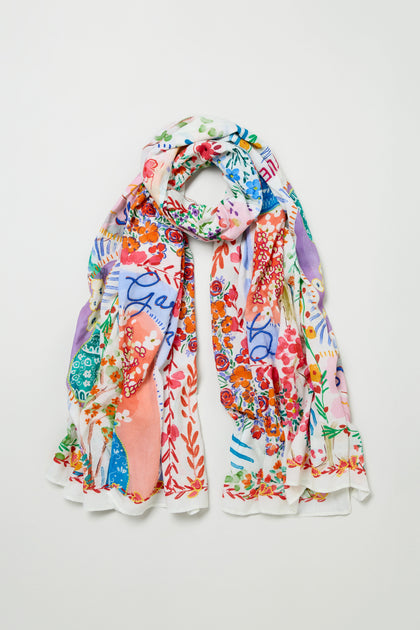 The Floral Bouquet Cotton Scarf is a lightweight cotton accessory with a colorful, abstract floral print in red, blue, green, and purple tones, shown laid flat on a white background.