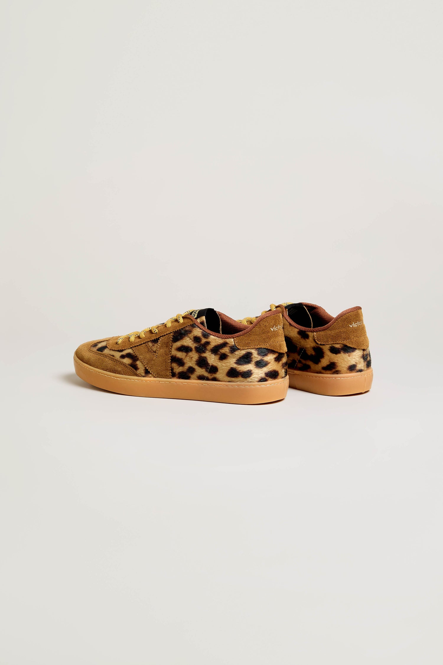 Pair of Berlin Animal Print Trainers featuring a bold leopard pattern, tan suede accents, vibrant yellow laces, and light brown rubber soles—expertly crafted in Spain as premium suede panel sneakers displayed on a plain white background.