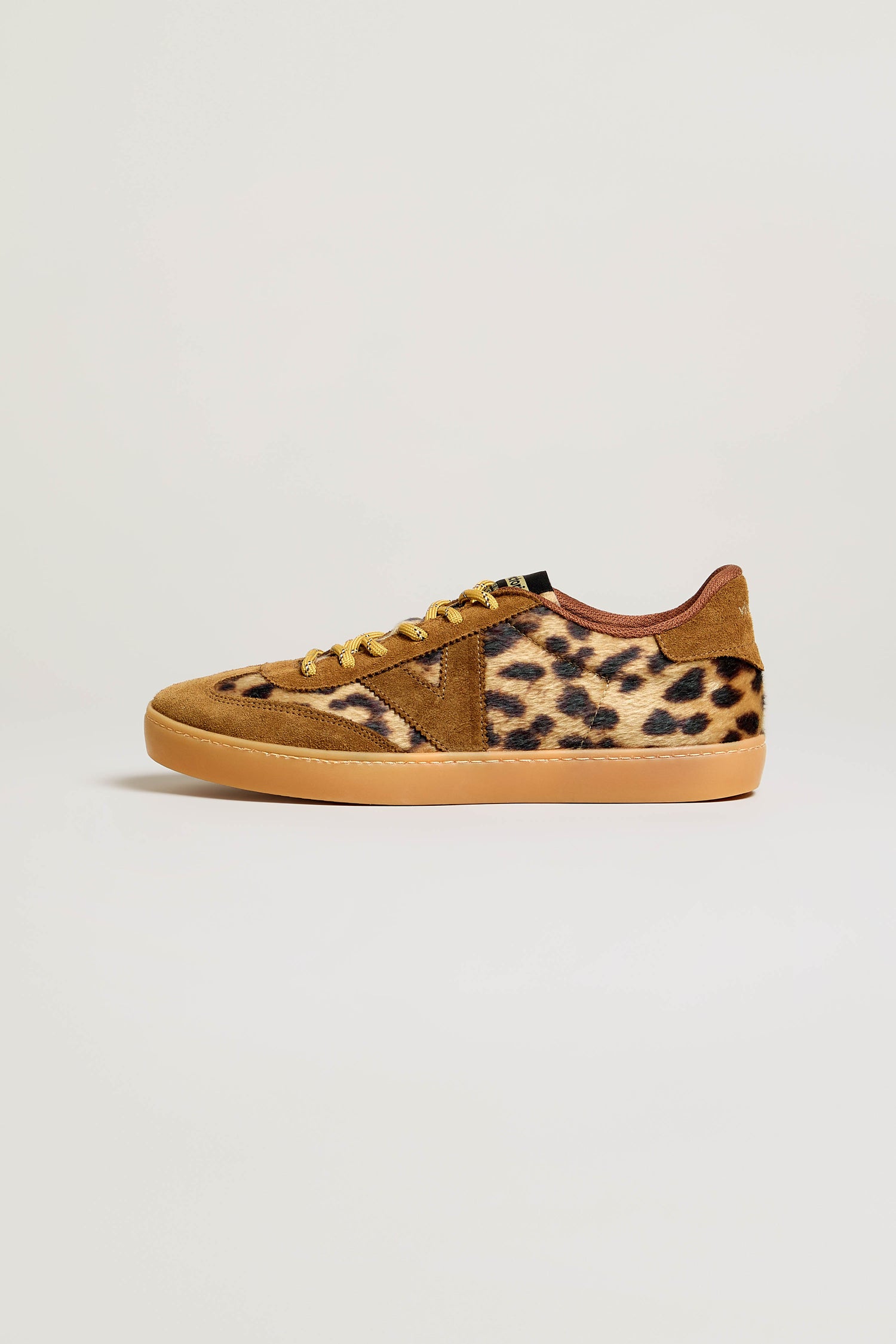The Berlin Animal Print Trainers feature brown and tan suede panels, leopard print sides, suede accents, and a tan rubber sole. Made in Spain, these sneakers are displayed against a plain white background.