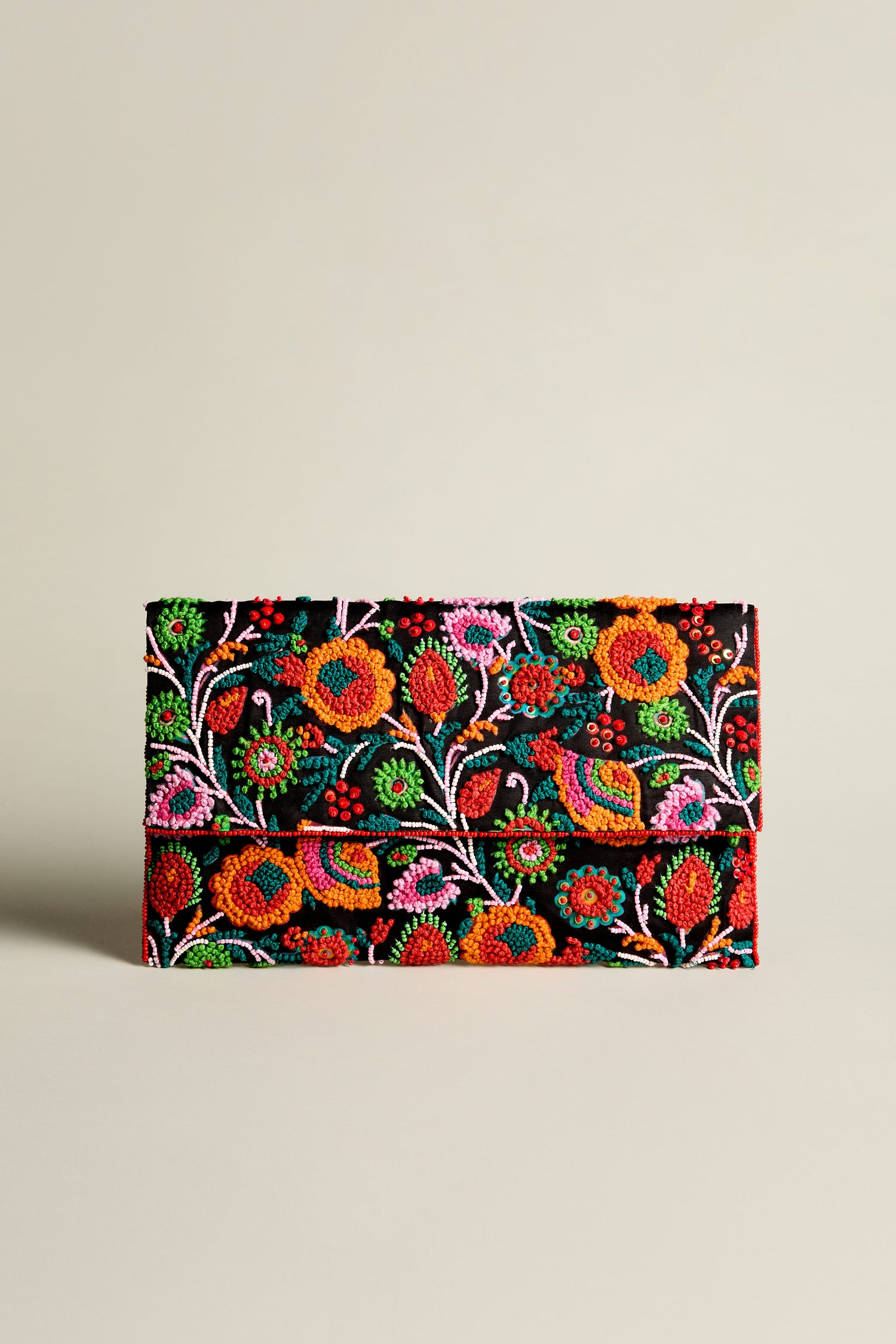 The Full Bloom Hand Beaded Clutch Bag is a stunning black accessory, adorned with colorful, intricate floral embroidery that features vibrant pink, red, green, and yellow flowers alongside charming birds. This hand-beaded clutch exudes floral beauty and adds a touch of elegance to any outfit.