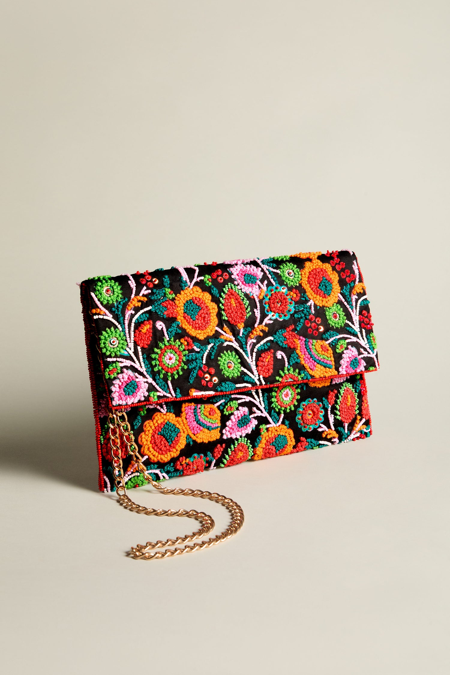 A chic Full Bloom Hand Beaded Clutch Bag featuring a stunning floral beauty design and a gold chain strap.