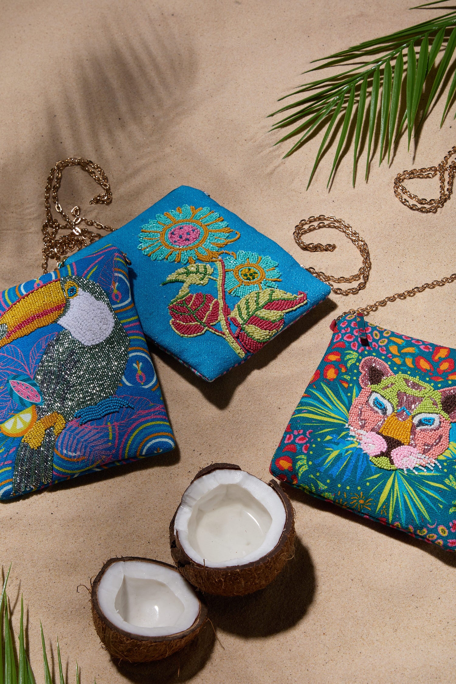 Colorful Hand Beaded Tiger Handbags with tropical designs displayed among coconut halves and palm fronds.
Product Name: Hand Beaded Tiger Handbag