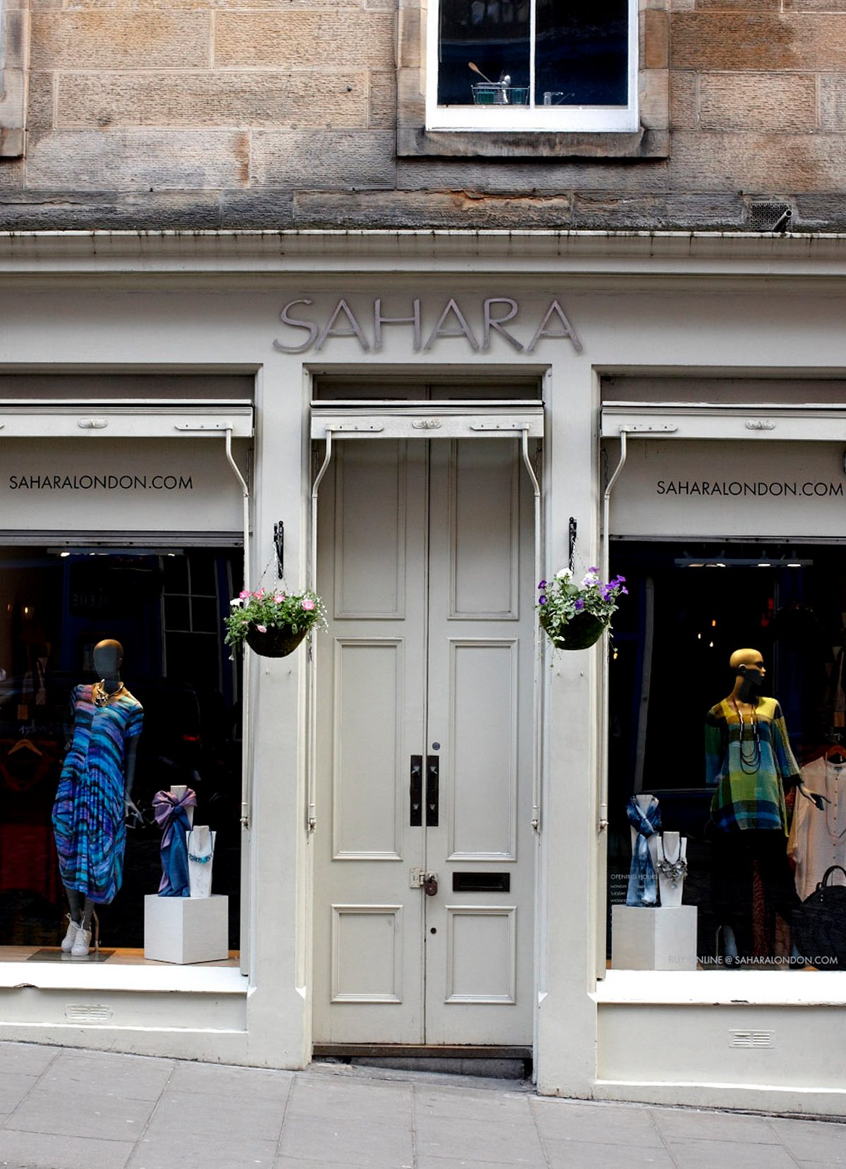 large white doors next to mannequins with sahara clothing