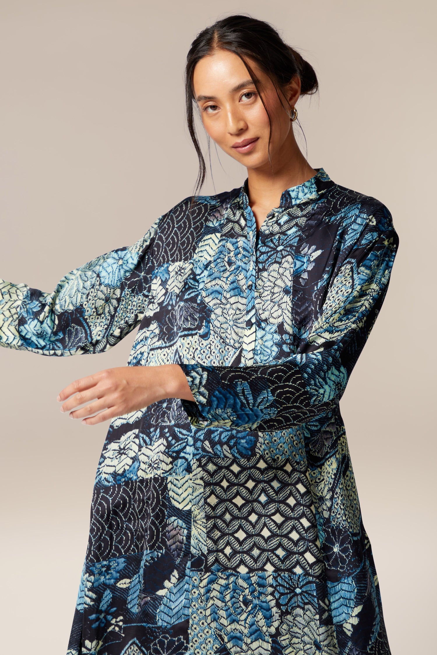 A woman wearing the Symphony Shirt Dress, an ethereal blue and black printed woven dress.