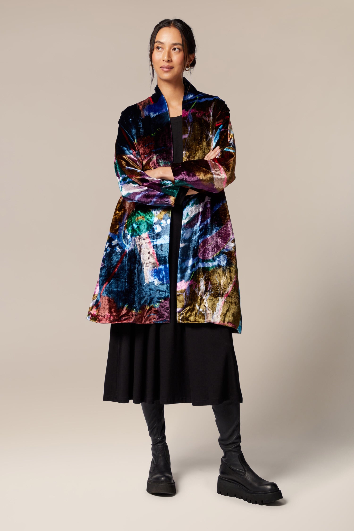 A woman wearing a floral velvet jacket with a classic shawl collar.