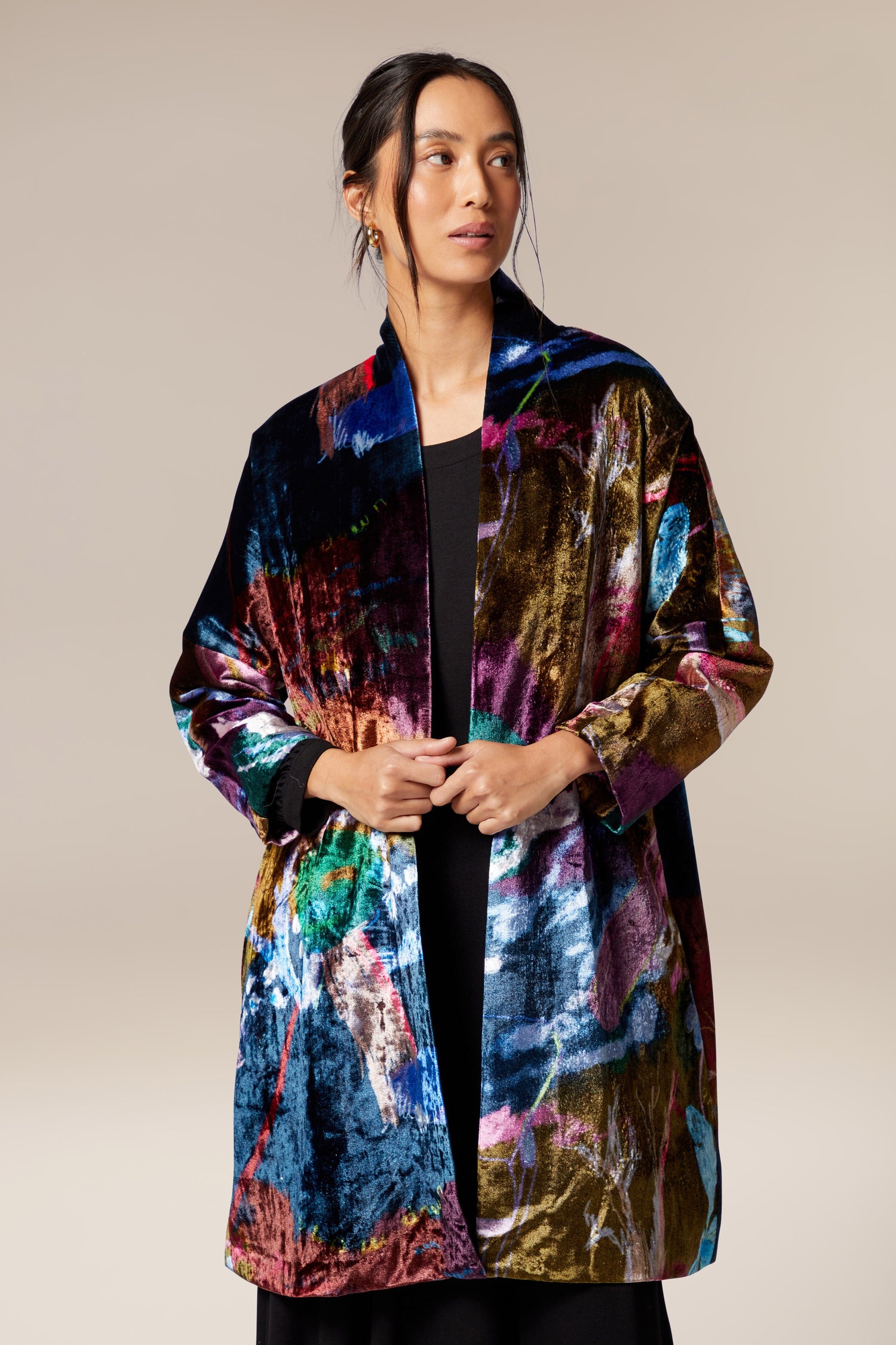 A woman wearing a Floral Velvet Jacket with a classic shawl collar.