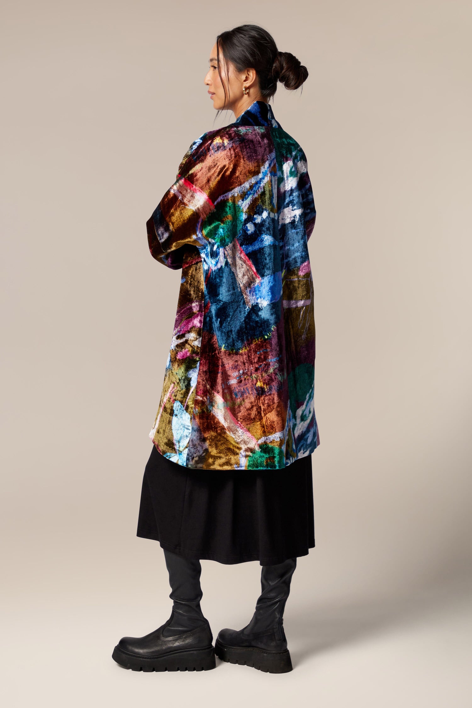 The back view of a woman wearing a Floral Velvet Jacket in a longline silhouette.