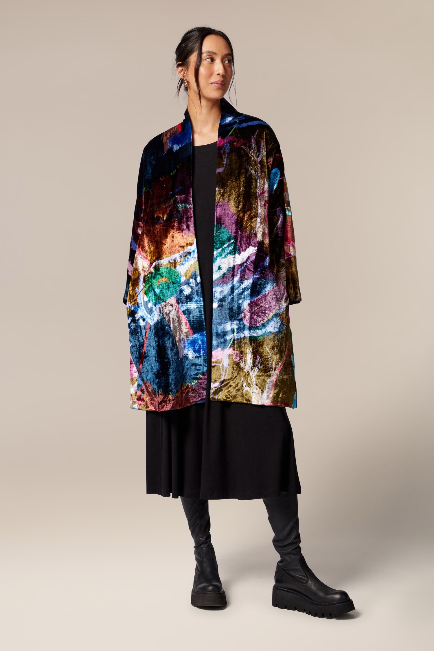 A woman wearing a Floral Velvet Jacket with a classic shawl collar.