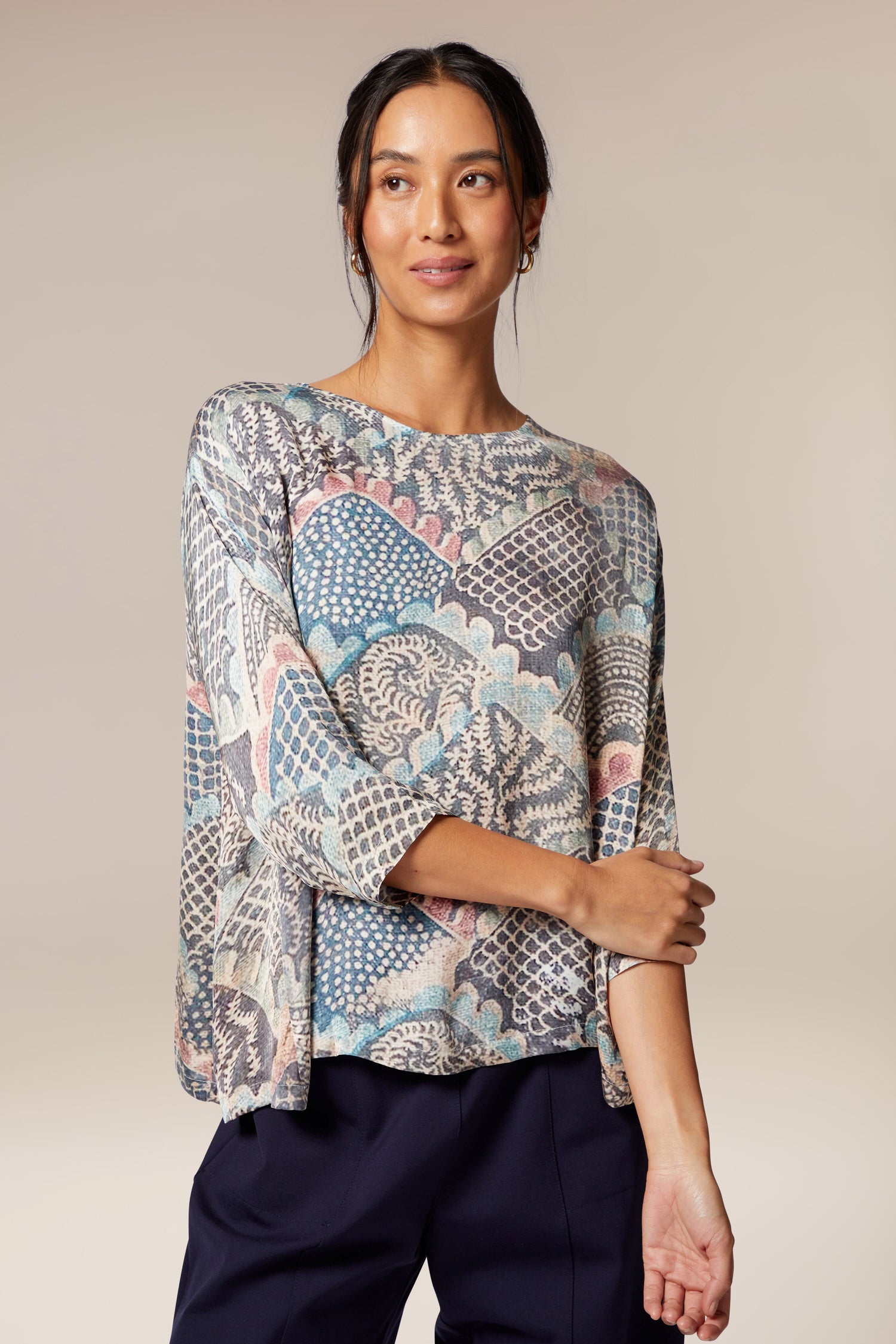 A woman wearing a Mosaic Print Top with paisley print.