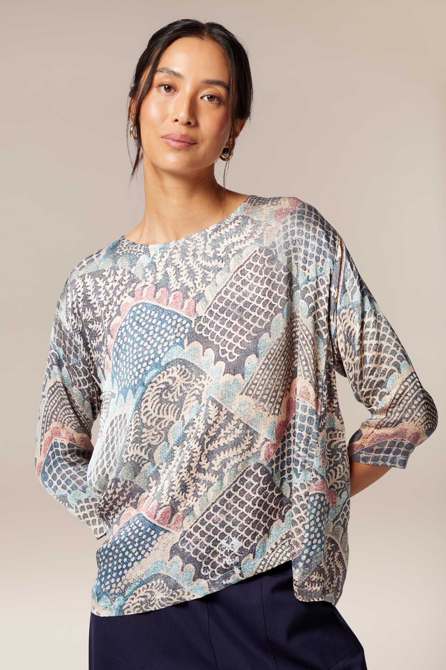 A woman wearing a Mosaic Print Top with a paisley print.