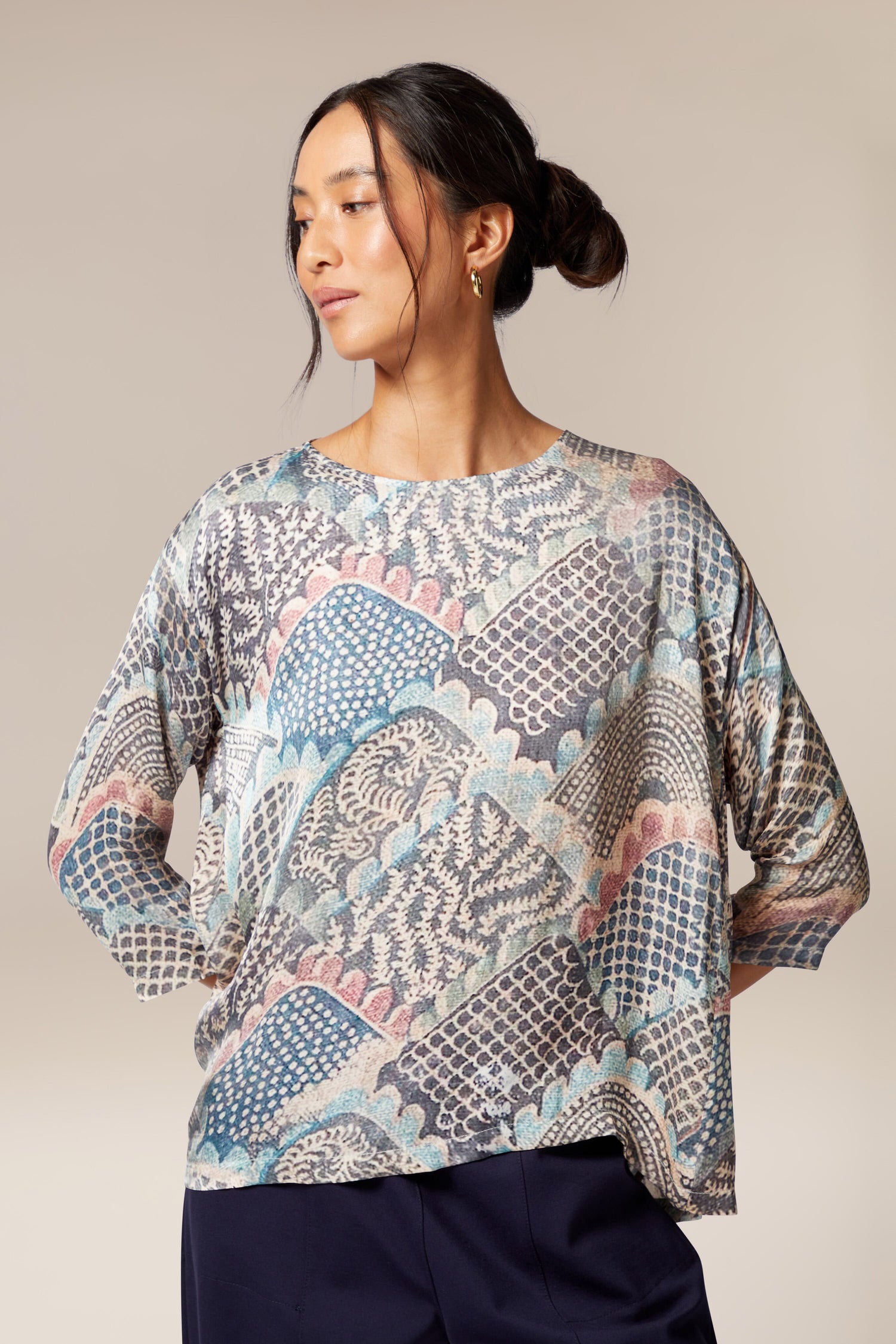 A woman wearing a Mosaic Print Top with a paisley printed pattern.