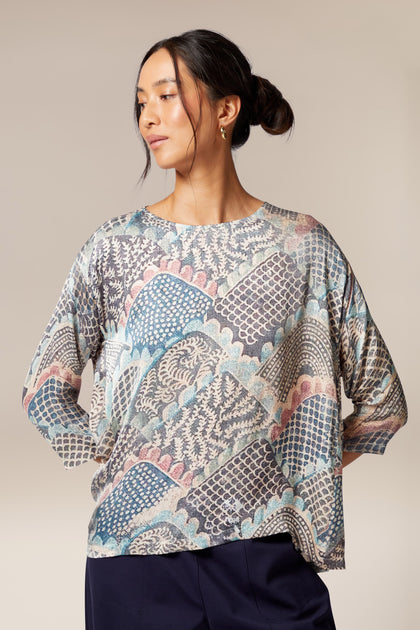 A woman wearing a Mosaic Print Top with a paisley printed pattern.