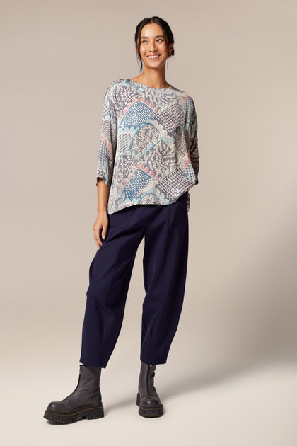 A woman wearing a Mosaic Print Top and trousers.