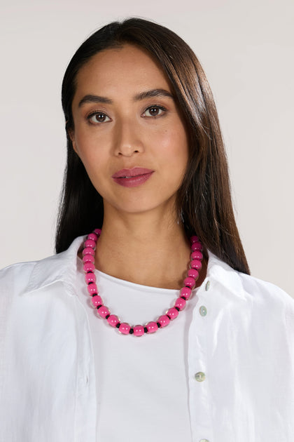 A woman with long, straight hair wears a white shirt and a Colourful Beads Necklace with a magnetic closure, looking directly at the camera.