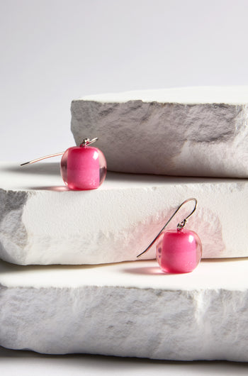 Two Colourful Bead Earrings, part of the Bellisima Collection, displayed elegantly on stacked rough-edged white stone slabs.