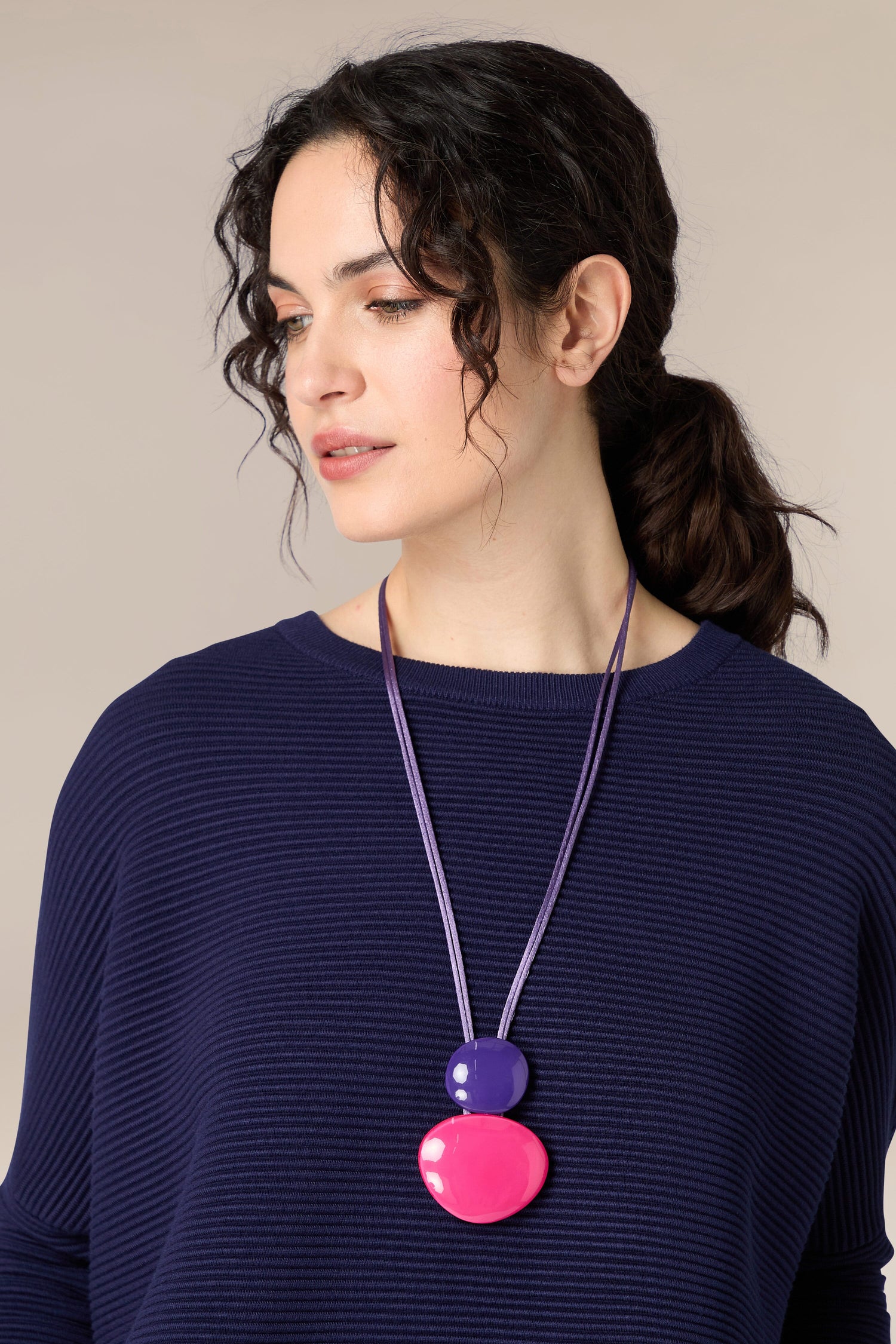 A woman wearing an organic OROSAI Resin Sphere Pendant necklace.