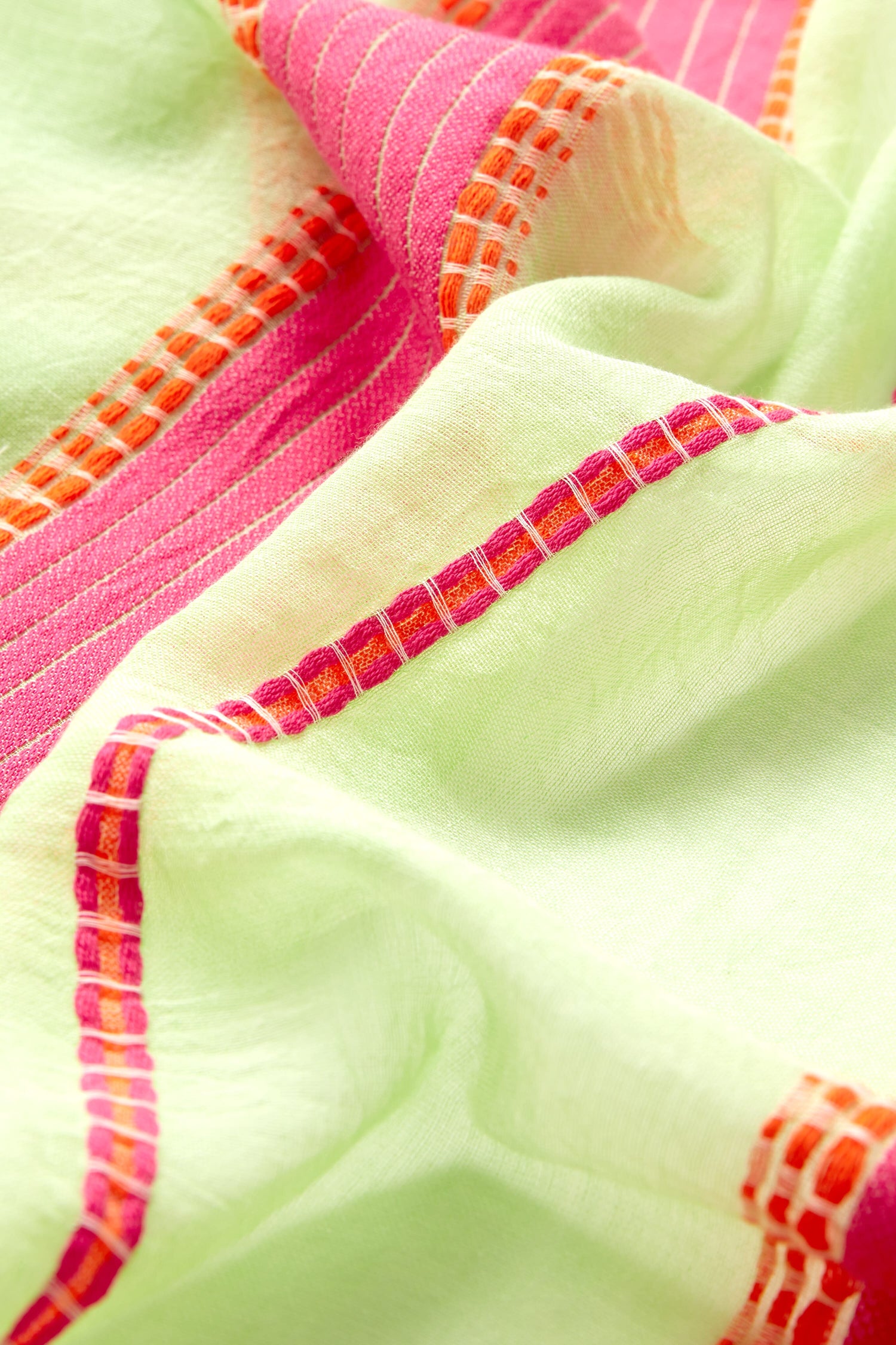 Sentence with Product Name: Close-up of a vibrant pink and green lightweight Embroidered Stripe Scarf.