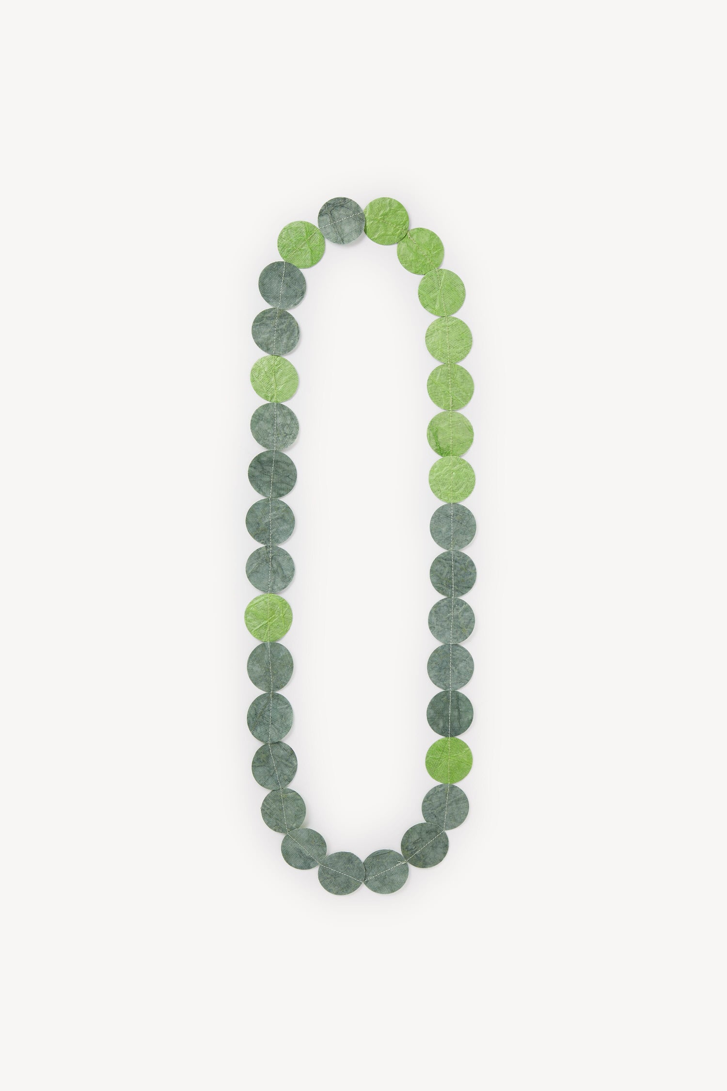 Dotty Necklace, delicate leaves arranged in a vertical oval shape on a white background.
