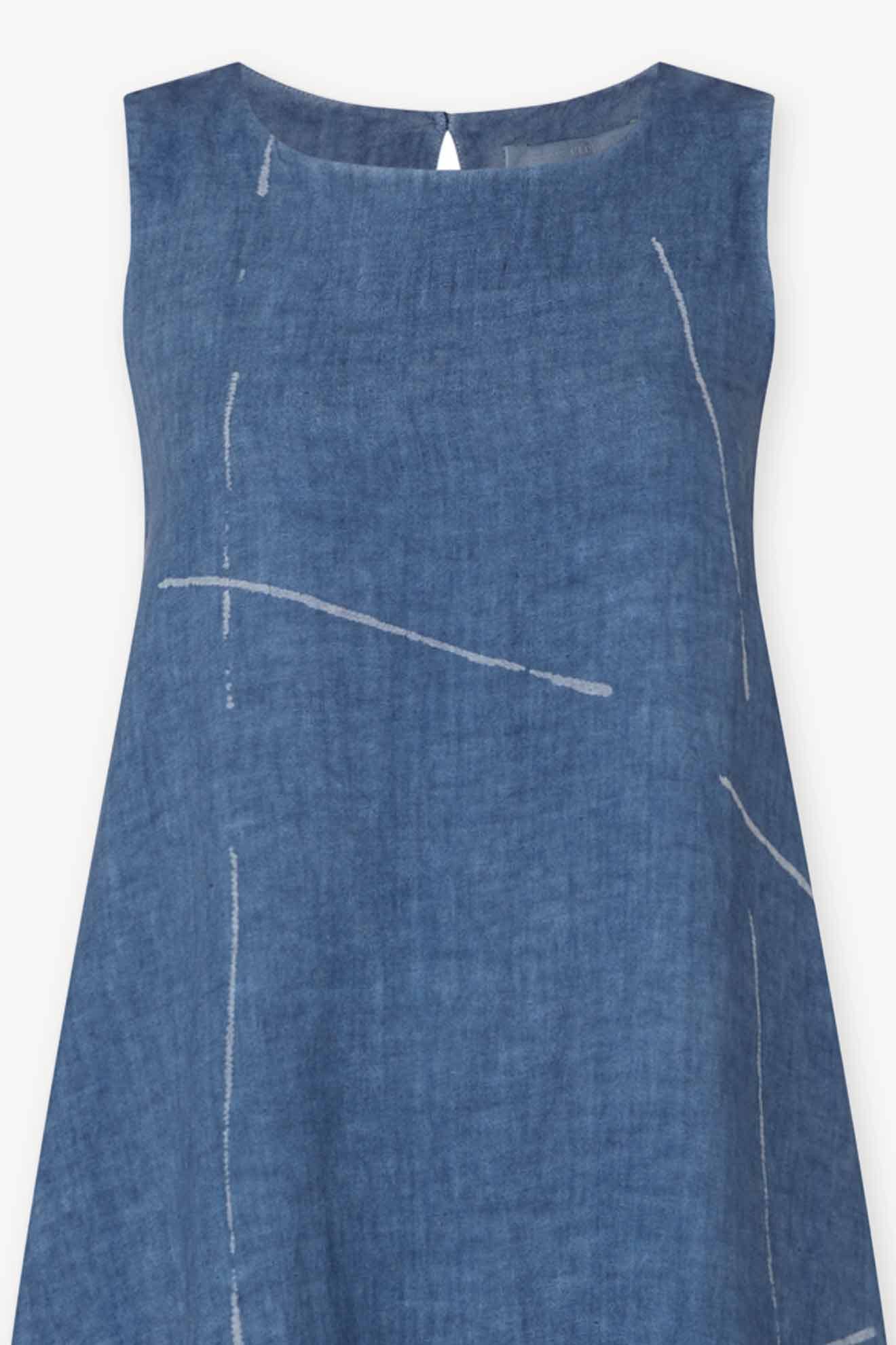 The Som Linen Dress is a minimalist sleeveless dress made from eco-friendly linen, featuring a relaxed A-line silhouette, round neckline, and subtle white line patterns on soft blue fabric.