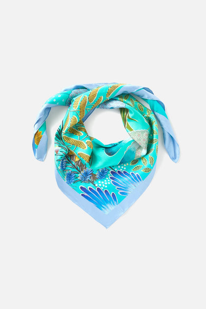A Moonlight Leopard Silk Scarf with a tropical print.