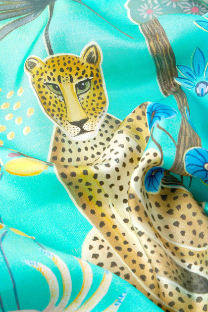 A Moonlight Leopard Silk Scarf with a leopard print.