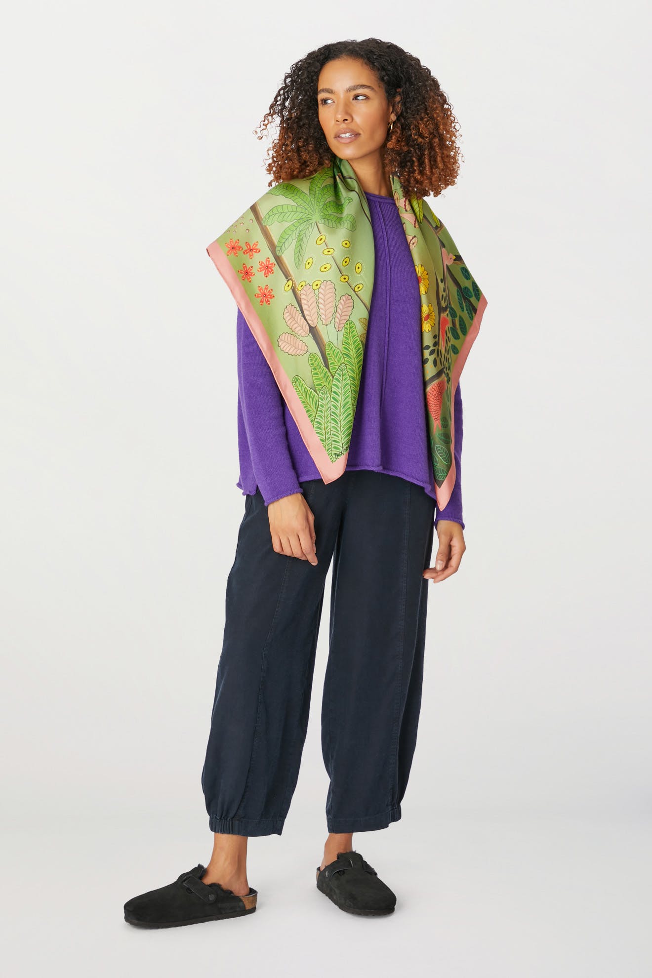 An artist wearing purple pants and the "Are You Coming With Me Silk Scarf".
